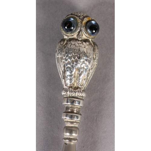 274 - A VICTORIAN SILVER OWL BUTTON HOOK, the double-sided handle as an owl with brown and blue glass eyes... 