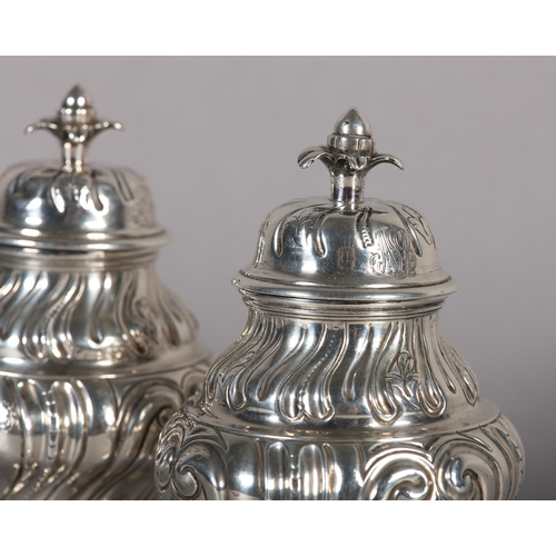 242 - A PAIR OF GEORGE II SILVER CADDIES, Alexander Johnson, London 1757, of writhen baluster vase form wi... 