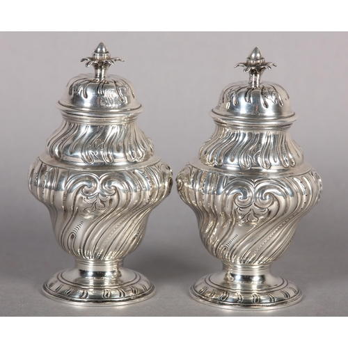 242 - A PAIR OF GEORGE II SILVER CADDIES, Alexander Johnson, London 1757, of writhen baluster vase form wi... 