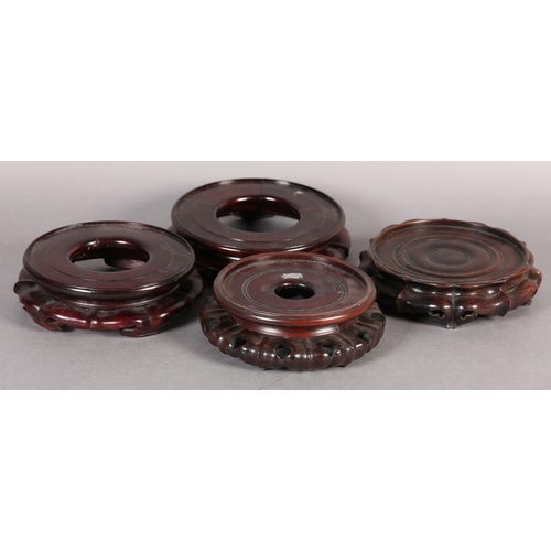 168B - FOUR GOOD QUALITY CHINESE CARVED AND PIERCED ROSEWOOD VASE STANDS, circular, each 20cm diameter