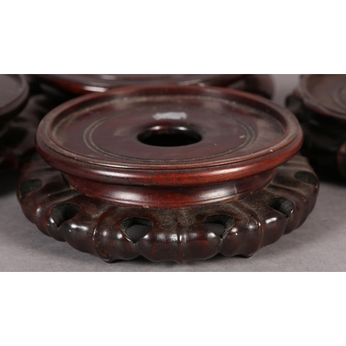 168B - FOUR GOOD QUALITY CHINESE CARVED AND PIERCED ROSEWOOD VASE STANDS, circular, each 20cm diameter