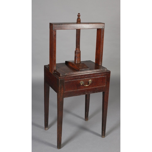 466 - A LATE 18TH CENTURY MAHOGANY BOOK PRESS, the stand having a frieze drawer with braSs handle, on squa... 