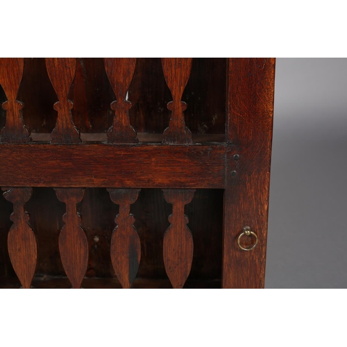 467 - AN 18TH CENTURY OAK HANGING LIVERY CUPBOARD, the single door pierced with two rows of spindle forms,... 