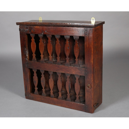 467 - AN 18TH CENTURY OAK HANGING LIVERY CUPBOARD, the single door pierced with two rows of spindle forms,... 