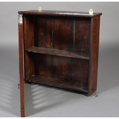 467 - AN 18TH CENTURY OAK HANGING LIVERY CUPBOARD, the single door pierced with two rows of spindle forms,... 