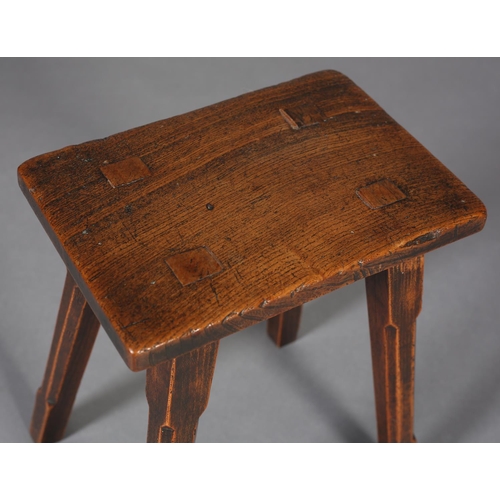 468 - A LATE 18TH CENTURY ELM STOOL, rectangular, with fruitwood joint pegs, on square tapered and chamfer... 