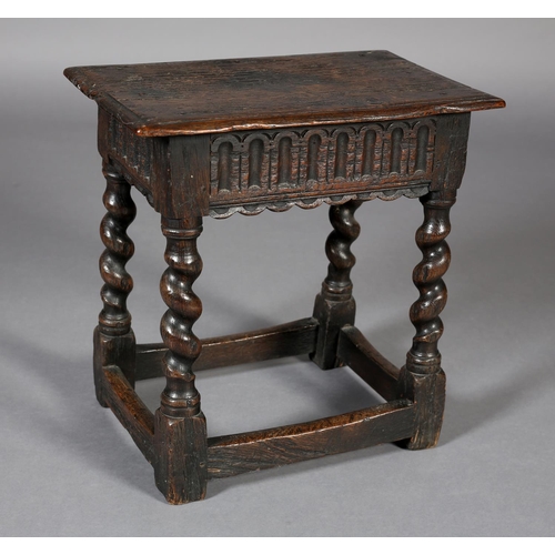 469 - AN EARLY 18TH CENTURY STYLE OAK JOYNT STOOL, the seat with moulded edge above an arcaded apron, on b... 