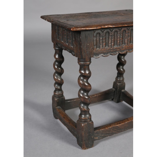 469 - AN EARLY 18TH CENTURY STYLE OAK JOYNT STOOL, the seat with moulded edge above an arcaded apron, on b... 