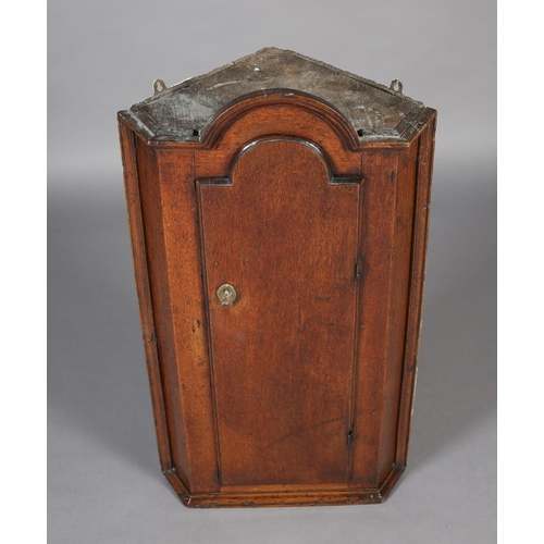 472 - A MID 18TH CENTURY OAK HANGING CORNER CUPBOARD, of arched profile with moulded cornice and sides, ab... 