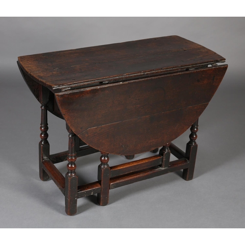 470 - A MID 18TH CENTURY OAK GATELEG TABLE, having twin oval drop leaves, on turned and square framing, 12... 