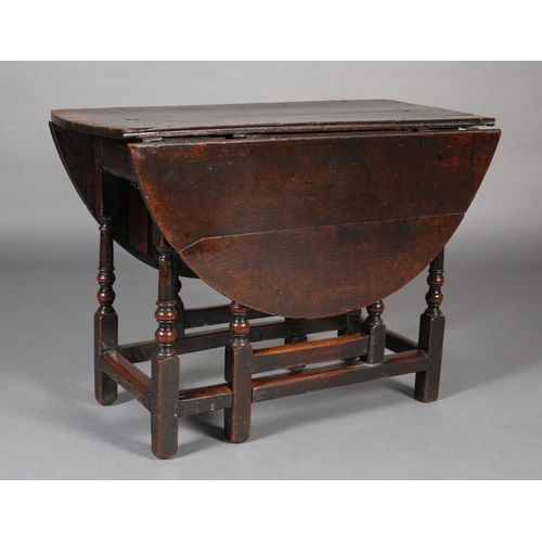 470 - A MID 18TH CENTURY OAK GATELEG TABLE, having twin oval drop leaves, on turned and square framing, 12... 