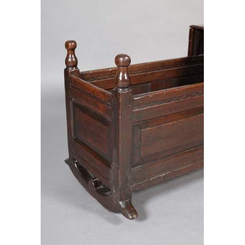 471 - A MID 18TH CENTURY OAK CRADLE, having a square canopy with hinged top, field panelled to all sides, ... 