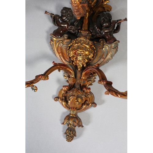 70 - A PAIR OF GILT AND BRONZED METAL TRIPLE LIGHT WALL SCONES, cast as a crowned orb above a shield moun... 