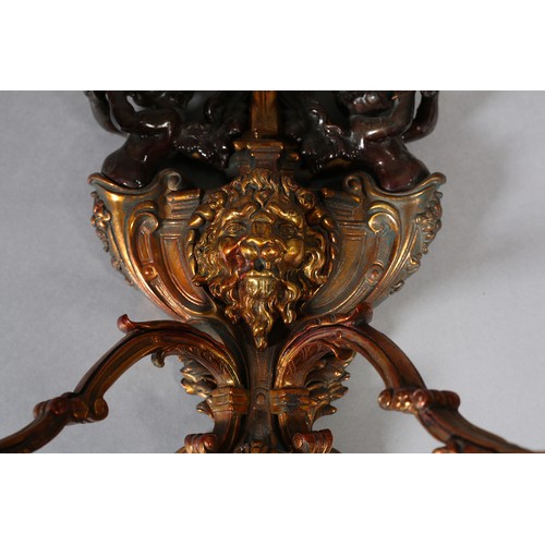 70 - A PAIR OF GILT AND BRONZED METAL TRIPLE LIGHT WALL SCONES, cast as a crowned orb above a shield moun... 