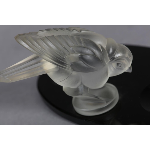 177B - A FRENCH MOULDED OPAQUE GLASS BIRD, mounted on a black glass desk tidy of oval outline, c.1930s, 17.... 