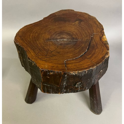 92B - AN EARLY 19TH CENTURY YEW-WOOD STOOL, the seat rough cut from the tree, the surface polished, on thr... 