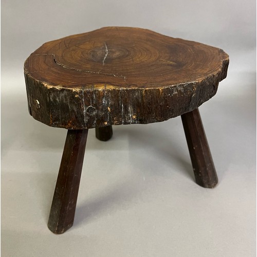 92B - AN EARLY 19TH CENTURY YEW-WOOD STOOL, the seat rough cut from the tree, the surface polished, on thr... 