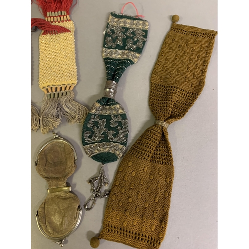 242 - Seven 19th century miser’s purses, the first crocheted in lemon with clear beads, linked with red st... 