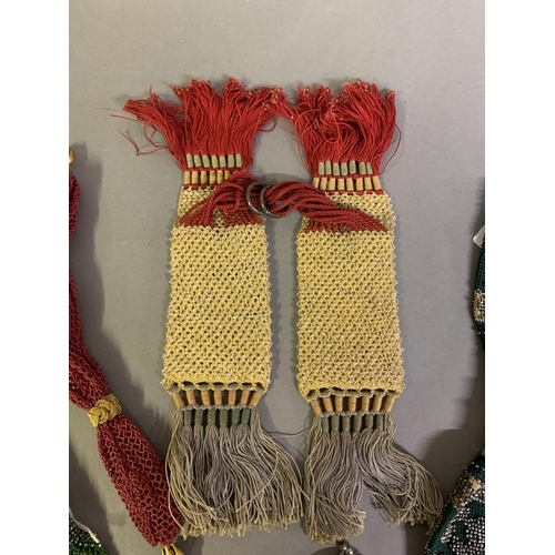 242 - Seven 19th century miser’s purses, the first crocheted in lemon with clear beads, linked with red st... 