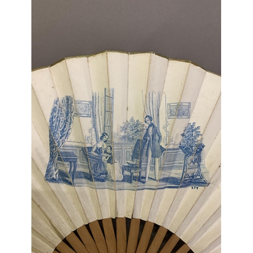 24 - A 19th century printed fan with wood monture showing a formal family scene, in a grand house, possib... 