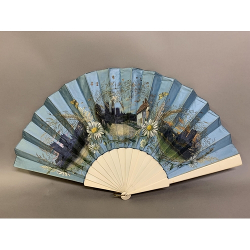 35 - A c 1890’s topographical fan, the plain bone monture mounted with a silk leaf in turquoise blue, pai... 