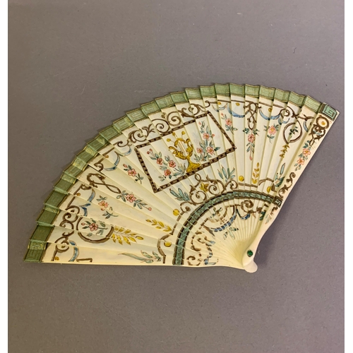 34 - A dainty early 20th century painted bone brisé fan, with central cartouche and two side ovals, flowe... 