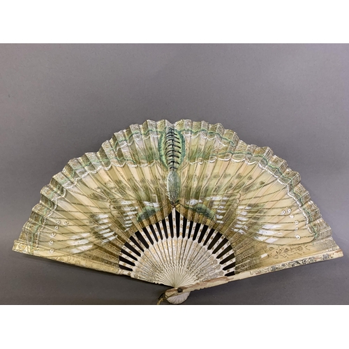 25 - A moth or butterfly fan, the paper leaf shaped, with embossed gold decoration and minute gold dots, ... 