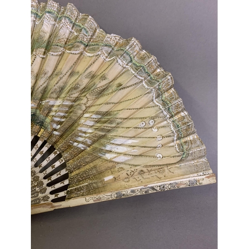 25 - A moth or butterfly fan, the paper leaf shaped, with embossed gold decoration and minute gold dots, ... 