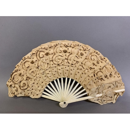 25 - A moth or butterfly fan, the paper leaf shaped, with embossed gold decoration and minute gold dots, ... 