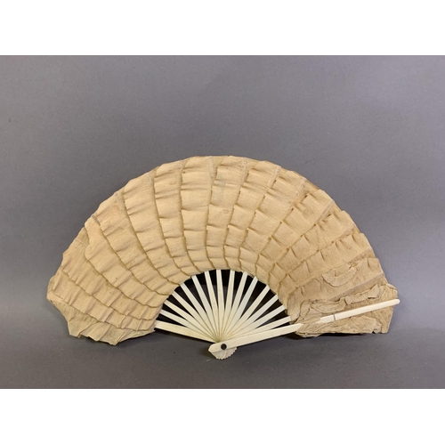 25 - A moth or butterfly fan, the paper leaf shaped, with embossed gold decoration and minute gold dots, ... 