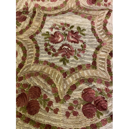 168 - A circular, silk embroidered table cover, with floral design, macramé fringing, worked in concentric... 