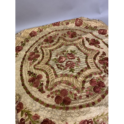 168 - A circular, silk embroidered table cover, with floral design, macramé fringing, worked in concentric... 