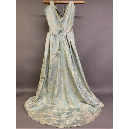 222 - A silk gown bearing the woven waist label of Eliza Pultz, 27 Dover Street, London, the aqua silk wov... 