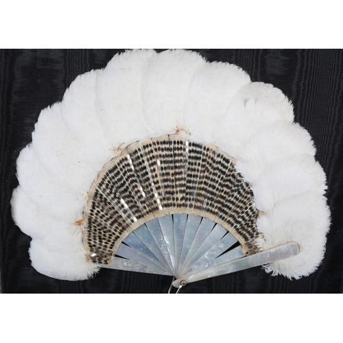 112 - Belle Epoque: A white feather and sequin fan, circa 1905, the monture of white mother of pearl, the ... 