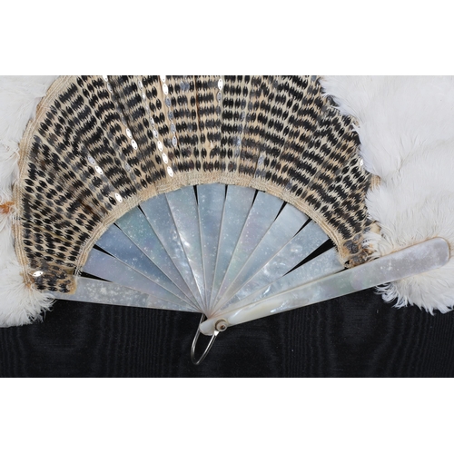 112 - Belle Epoque: A white feather and sequin fan, circa 1905, the monture of white mother of pearl, the ... 