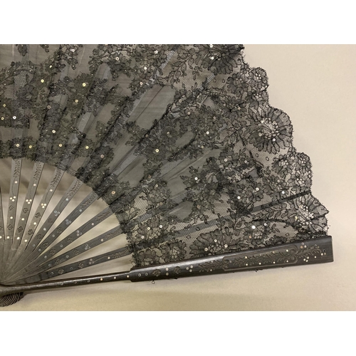 12 - Three large c 1890’s fans, all on black wood, the first with a deep border of painted butterflies, f... 