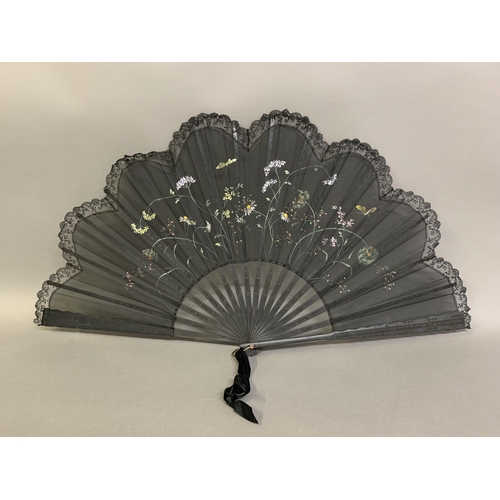 12 - Three large c 1890’s fans, all on black wood, the first with a deep border of painted butterflies, f... 