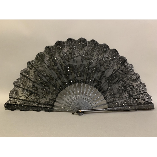 12 - Three large c 1890’s fans, all on black wood, the first with a deep border of painted butterflies, f... 