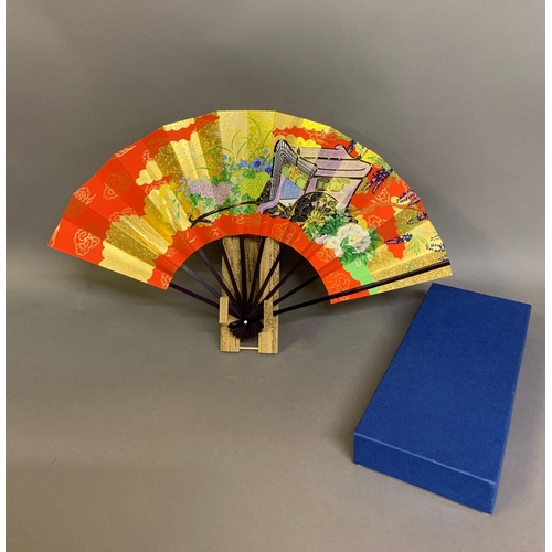 142 - Twentieth century Chinese and Japanese fans: a large folding paper fan, the plain wood sticks with w... 