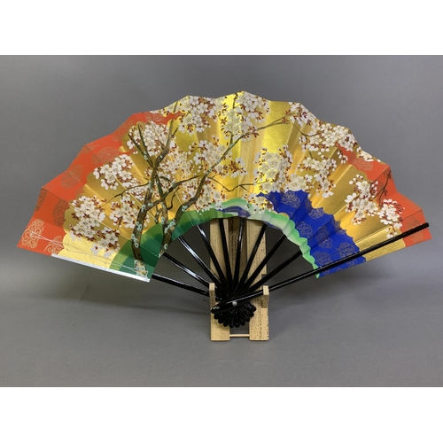 142 - Twentieth century Chinese and Japanese fans: a large folding paper fan, the plain wood sticks with w... 