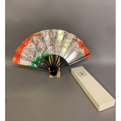 142 - Twentieth century Chinese and Japanese fans: a large folding paper fan, the plain wood sticks with w... 