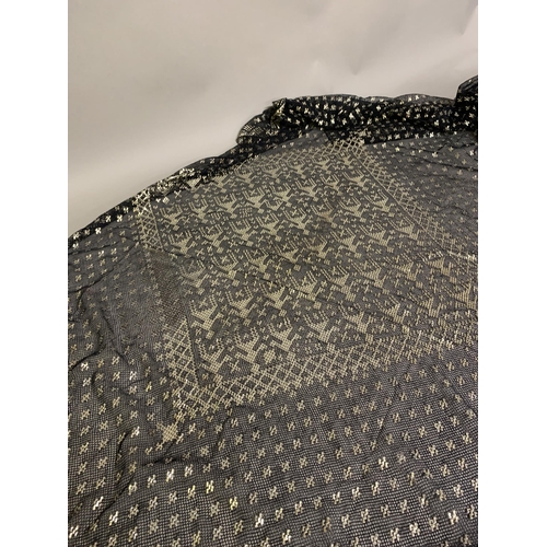 276 - 1920’s, a wide black azute or assuit shawl, the pressed silver decoration in stylized, geometric des... 