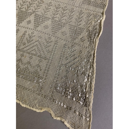 271 - 1920’s, a wide cream azute or assuit shawl, the pressed silver decoration in multiple bands of styli... 