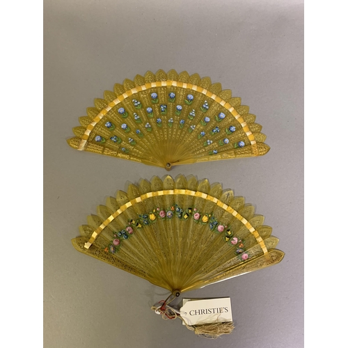 20 - Two Early 19th Century Horn Brisé Fans, both carved and pierced, the stick tips pointed, one painted... 