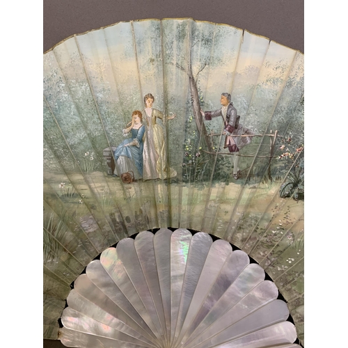 43 - A white mother of pearl and painted silk fan, early 20th century, a gentle scene set by water, a sui... 