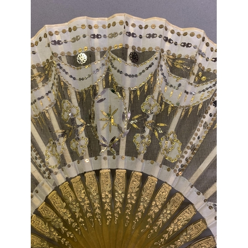 46 - Two fans C 1900/1910, the first a small gold sequin fan, the leaf of gold lamé overlaid with cream s... 