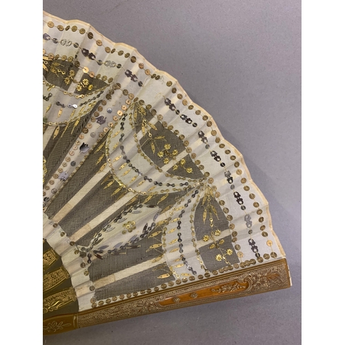 46 - Two fans C 1900/1910, the first a small gold sequin fan, the leaf of gold lamé overlaid with cream s... 