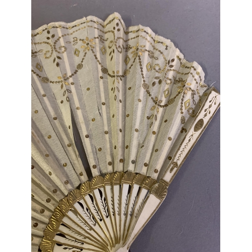 46 - Two fans C 1900/1910, the first a small gold sequin fan, the leaf of gold lamé overlaid with cream s... 