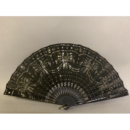 39 - Three fans, the first late 19th century, wood sticks painted black and mounted with a fabric leaf of... 