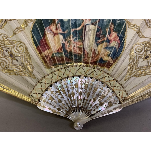 18 - A Regency period white mother of pearl fan, the monture decoratively gilded, the upper guards carved... 